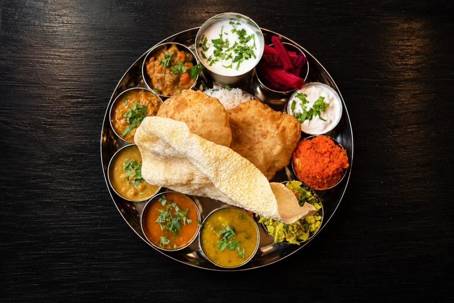 A full thali with curries, poori and papad